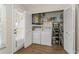 Laundry room with washer, dryer, water heater, and shelving for cleaning supplies at 1535 Nursery Rd # 110, Clearwater, FL 33756