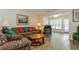 Comfortable living room with floral patterned sofas and wood-look floors at 1535 Nursery Rd # 110, Clearwater, FL 33756