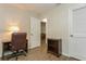Office with wood-look floors featuring desk and chair, bookcase, and doors at 1535 Nursery Rd # 110, Clearwater, FL 33756