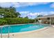 Community pool area with sun shelter, tables and chairs, and a well-maintained deck at 1535 Nursery Rd # 110, Clearwater, FL 33756