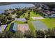 Aerial view of the community park with a playground, sports courts, and parking by the lake at 16248 Ivy Lake Dr, Odessa, FL 33556