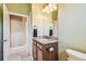 Bathroom features a granite vanity, tile floor, and neutral green paint at 16248 Ivy Lake Dr, Odessa, FL 33556