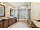 Luxurious bathroom featuring double sinks, a soaking tub, and elegant fixtures at 16248 Ivy Lake Dr, Odessa, FL 33556