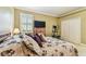 Comfortable bedroom with a large window, exercise equipment, and a double door closet at 16248 Ivy Lake Dr, Odessa, FL 33556