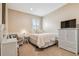 Neutral bedroom featuring white wicker furniture, a window with shutters, and chair at 16248 Ivy Lake Dr, Odessa, FL 33556