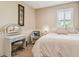 Bright bedroom featuring a vanity, window with shutters, and bed at 16248 Ivy Lake Dr, Odessa, FL 33556