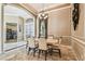 Formal dining room showcasing marble floors, decorative molding, and a stylish chandelier above the table at 16248 Ivy Lake Dr, Odessa, FL 33556