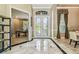 Elegant foyer with marble flooring, white trim, and double doors with decorative glass at 16248 Ivy Lake Dr, Odessa, FL 33556