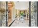 Elegant foyer with marble flooring, decorative columns, and views of the pool area at 16248 Ivy Lake Dr, Odessa, FL 33556