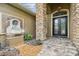 Close-up of front door with a brick surround and adjacent fountain feature at 16248 Ivy Lake Dr, Odessa, FL 33556