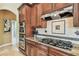 Modern kitchen featuring stainless steel appliances, granite countertops, and ample cabinet space at 16248 Ivy Lake Dr, Odessa, FL 33556