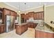 A kitchen featuring an island, stainless steel appliances, granite countertops, and dark wood cabinets at 16248 Ivy Lake Dr, Odessa, FL 33556