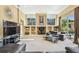 Bright living room with large windows, built-in shelving, modern furniture, and neutral color palette at 16248 Ivy Lake Dr, Odessa, FL 33556