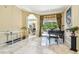 A spacious living room with marble floors, an arched doorway, and a view of the backyard and pool at 16248 Ivy Lake Dr, Odessa, FL 33556