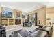 Spacious living room featuring large windows, built-in shelving, and a view of the outdoor pool at 16248 Ivy Lake Dr, Odessa, FL 33556