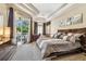 Inviting main bedroom with a view of the pool area, a comfortable bed, and warm natural lighting at 16248 Ivy Lake Dr, Odessa, FL 33556