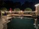 Inviting backyard pool with ambient string lights and outdoor seating area, perfect for evening relaxation at 16248 Ivy Lake Dr, Odessa, FL 33556