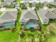 Aerial view of the property showcases the backyard pool, landscaping, and neighborhood layout at 1723 Pacific Dunes Dr, Sun City Center, FL 33573