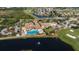 Aerial view of the community clubhouse, pool, and golf course surrounded by lush landscaping and beautiful homes at 1723 Pacific Dunes Dr, Sun City Center, FL 33573