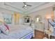 Comfortable bedroom featuring a bay window, wood flooring, and neutral paint at 1723 Pacific Dunes Dr, Sun City Center, FL 33573