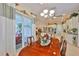 Dining area showcasing a wooden table and chairs, sliding glass doors to the outside, and view to kitchen at 1723 Pacific Dunes Dr, Sun City Center, FL 33573