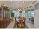 Dining room features a wood table, chairs, and a view of the outdoor pool area at 1723 Pacific Dunes Dr, Sun City Center, FL 33573