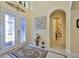 Bright foyer featuring double doors, tile floors, and decorative accents, creating an inviting entrance at 1723 Pacific Dunes Dr, Sun City Center, FL 33573