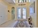 Welcoming foyer with tile flooring, decorative glass doors, and elegant decor setting a refined tone at 1723 Pacific Dunes Dr, Sun City Center, FL 33573