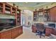 Inviting home office featuring custom built-ins, and large desk perfect for productivity and organization at 1723 Pacific Dunes Dr, Sun City Center, FL 33573
