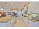 A bright kitchen features white cabinetry, stainless steel appliances and granite countertops at 1723 Pacific Dunes Dr, Sun City Center, FL 33573