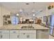 A kitchen island with stainless steel appliances overlooks the open-plan living room at 1723 Pacific Dunes Dr, Sun City Center, FL 33573
