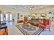 Spacious living room with coffered ceilings, tile floors, and a seamless open floor plan for modern living at 1723 Pacific Dunes Dr, Sun City Center, FL 33573