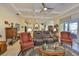 Spacious living room with coffered ceilings, tile floors, and a seamless open floor plan for modern living at 1723 Pacific Dunes Dr, Sun City Center, FL 33573