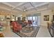 Spacious living room with coffered ceilings, tile floors, and a seamless open floor plan for modern living at 1723 Pacific Dunes Dr, Sun City Center, FL 33573