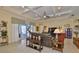 Spacious living room with coffered ceilings, tile floors, and a cozy seating arrangement at 1723 Pacific Dunes Dr, Sun City Center, FL 33573