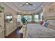 Main bedroom with hardwood floors, tray ceilings, and a cozy seating area at 1723 Pacific Dunes Dr, Sun City Center, FL 33573