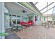 Spacious covered patio with ample seating areas, outdoor kitchen, and stunning views of the pool at 1723 Pacific Dunes Dr, Sun City Center, FL 33573