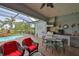 Serene screened patio with outdoor kitchen, dining area, and lounge seating overlooking a swimming pool at 1723 Pacific Dunes Dr, Sun City Center, FL 33573