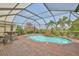 Inviting screened pool surrounded by brick pavers, beautiful landscaping, and serene golf course views at 1723 Pacific Dunes Dr, Sun City Center, FL 33573