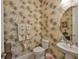 Quaint powder room with charming palm tree wallpaper, adding a touch of tropical elegance at 1723 Pacific Dunes Dr, Sun City Center, FL 33573