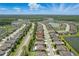 Expansive aerial view of a neighborhood with multiple lakes surrounded by green landscaping at 18596 Rococo Rd, Spring Hill, FL 34610