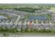 A high aerial view reveals a home in a community with a lake and neighborhood pool at 18596 Rococo Rd, Spring Hill, FL 34610
