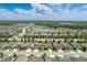 Aerial view of a home in a well-planned community with lakes and lush landscaping at 18596 Rococo Rd, Spring Hill, FL 34610