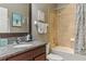 Well-lit bathroom with granite countertops, bathtub, and tiled shower, for a relaxing experience at 18596 Rococo Rd, Spring Hill, FL 34610