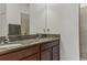 Elegant bathroom featuring double sinks with granite countertop and modern fixtures at 18596 Rococo Rd, Spring Hill, FL 34610