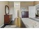 Bright bedroom with dark wood floors, two dressers, and easy access to the bathroom at 18596 Rococo Rd, Spring Hill, FL 34610