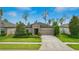 Charming single-story home features a well-manicured lawn, stone accents, and a two-car garage at 18596 Rococo Rd, Spring Hill, FL 34610