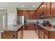 Well-equipped kitchen featuring stainless steel appliances, granite counters, tile floors, and ample cabinet space at 18596 Rococo Rd, Spring Hill, FL 34610