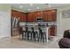 Open-concept kitchen with island seating, stainless steel refrigerator, and sleek microwave at 18596 Rococo Rd, Spring Hill, FL 34610