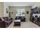 Comfortable living room with neutral walls, two sofas, a patterned rug, and a window at 18596 Rococo Rd, Spring Hill, FL 34610